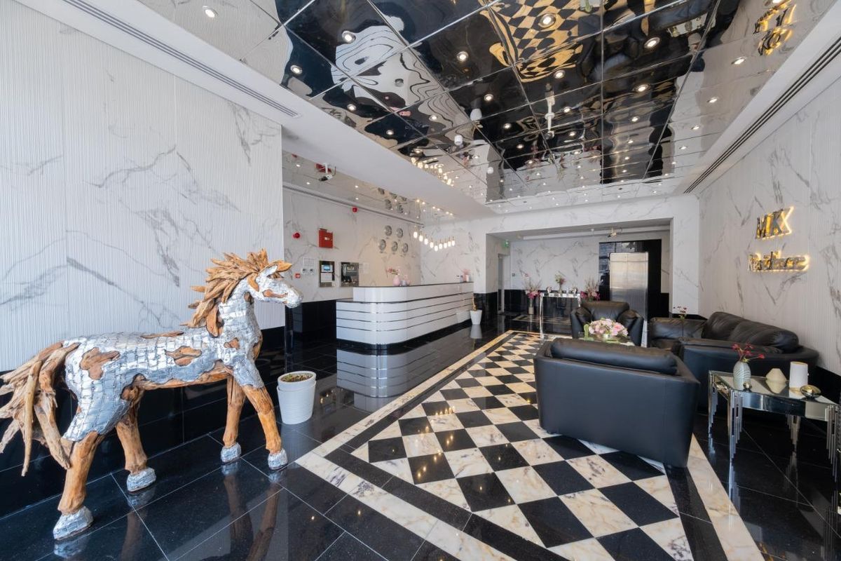 Lobby with a driftwood horse sculpture, the reception desk and leather armchairs